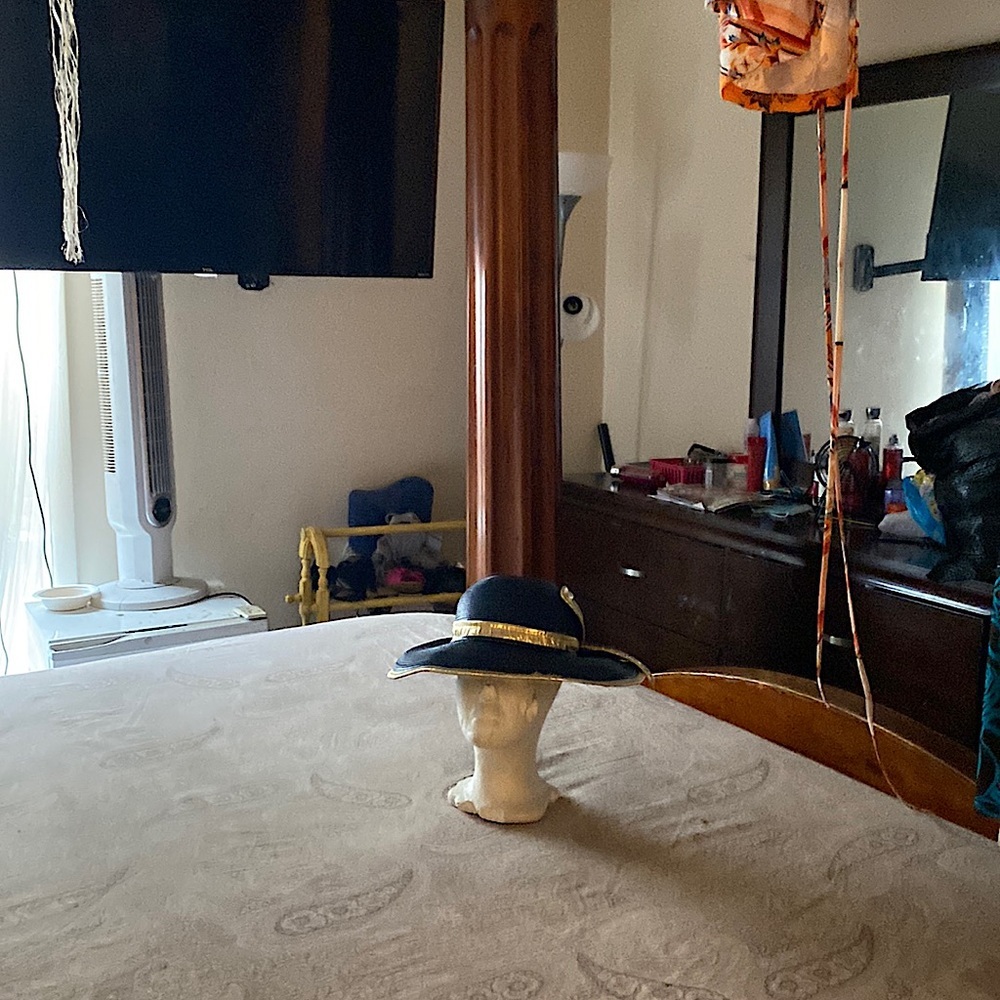 Navy blue hat trimmed in gold